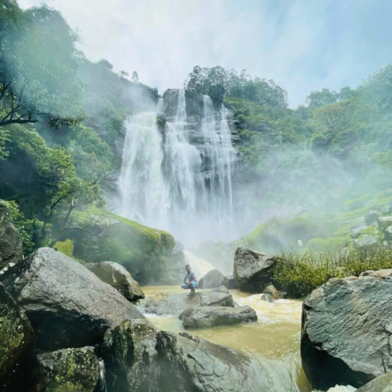 Bomburu Ella Waterfall surrounded by mist and forest vegetation