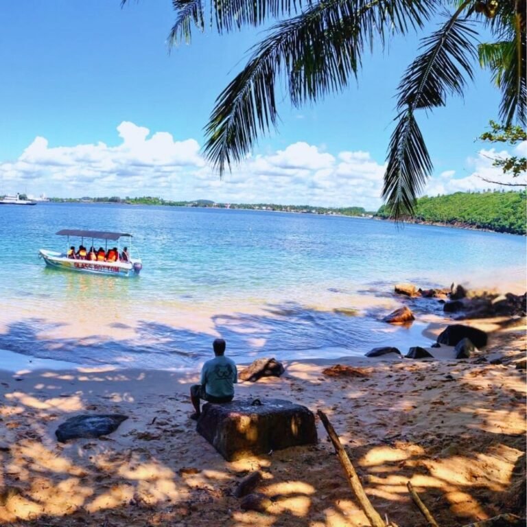 Tourists relaxing on the sandy shore of Jungle Beach