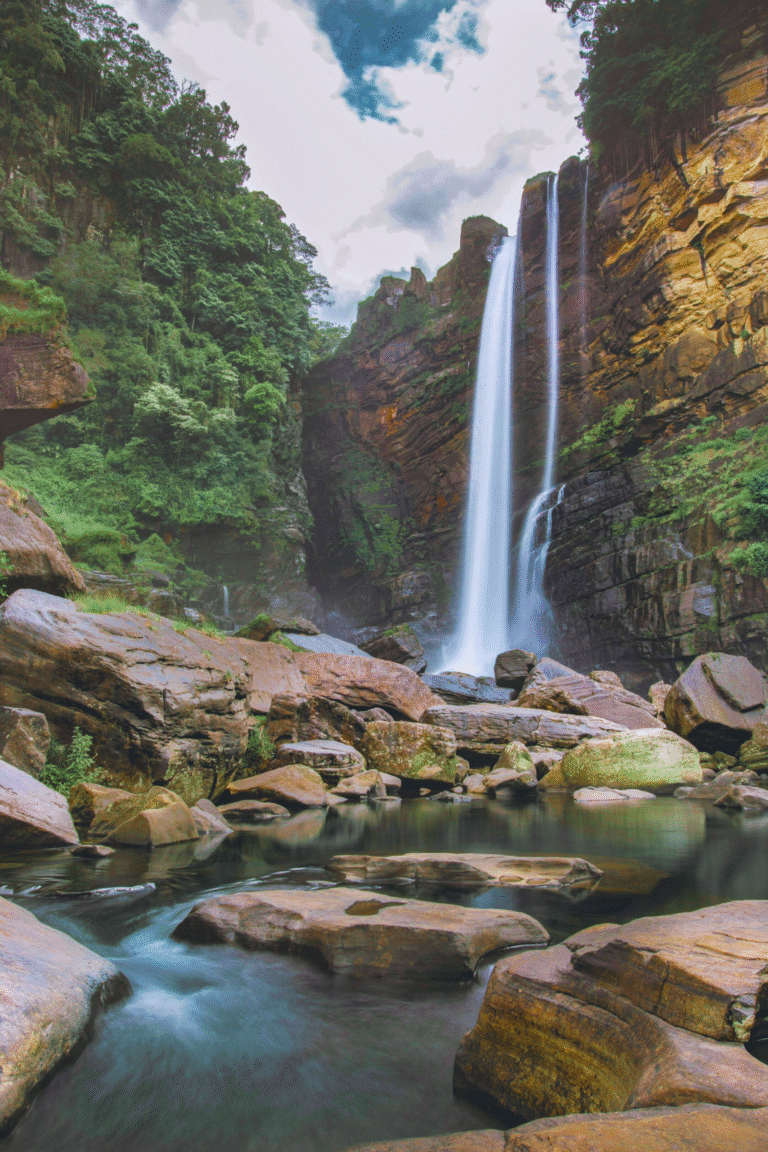 Scenic view of Laxapana Falls surrounded by greenery