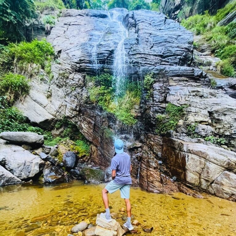 Waterfall flowing through the green valley of Mandaram Nuwara