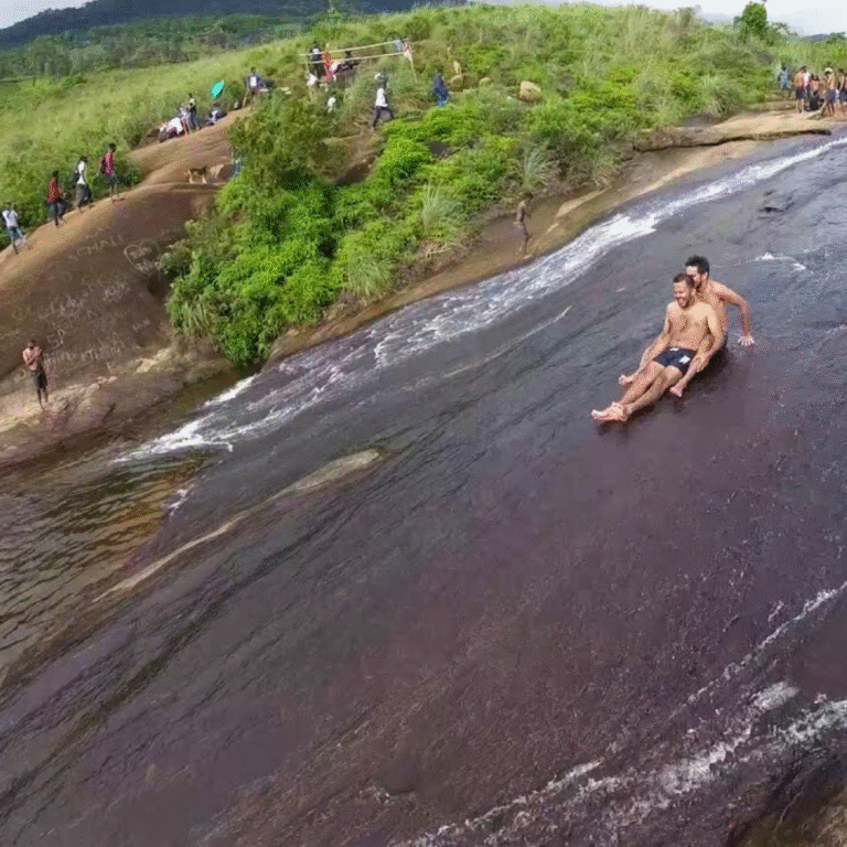 Tourists enjoying a water slide on Patna Rock