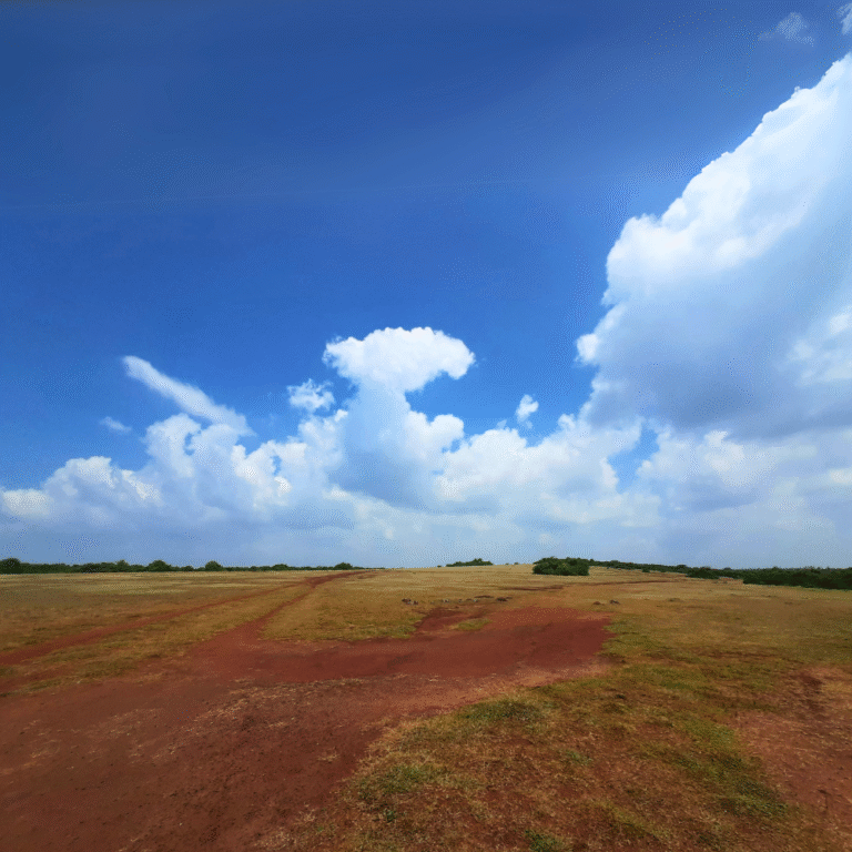 Natural red soil formations at Ussangoda under clear blue skies