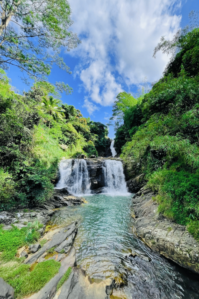 Kadiyanlena Waterfall surrounded by lush green forest in Sri Lanka