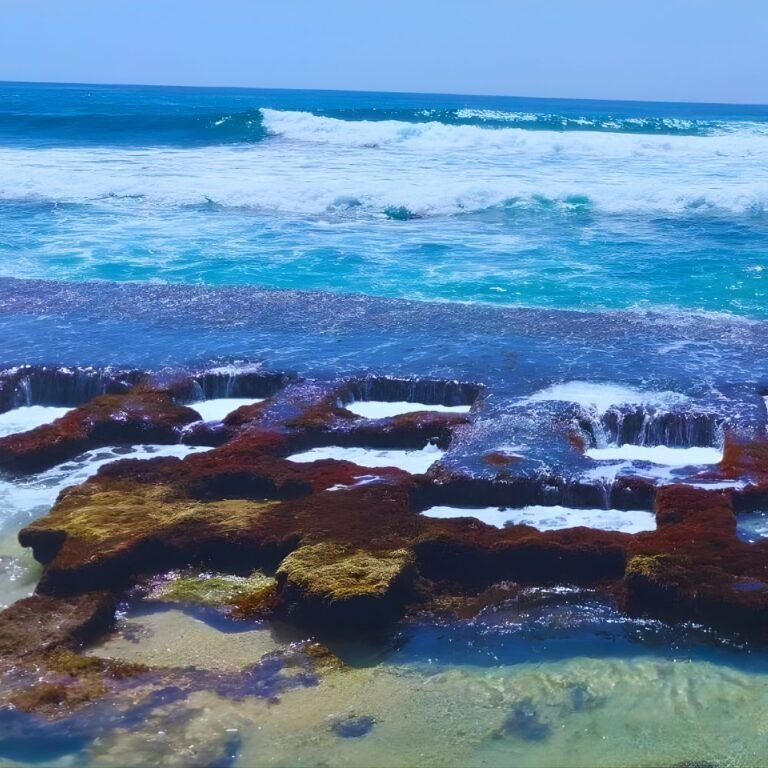 Calm waves hitting the golden sands of Thalpe Beach Sri Lanka