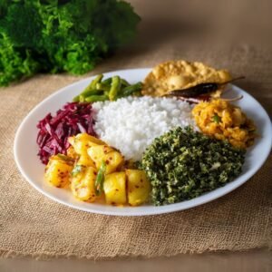 Plate of rice and curry in Sri Lanka with sambol and papadam