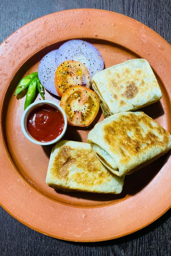 Close-up of crispy vegetable roti filled with spicy curry