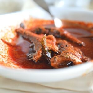 freshly cooked fish curry with chili and herbs