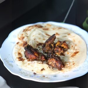 Freshly cooked Sri Lankan pol roti on banana leaf