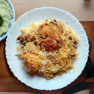 Colorful chicken biriyani garnished with fried onions