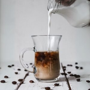 close-up of frothy milk coffee in a glass cup Sri Lanka style