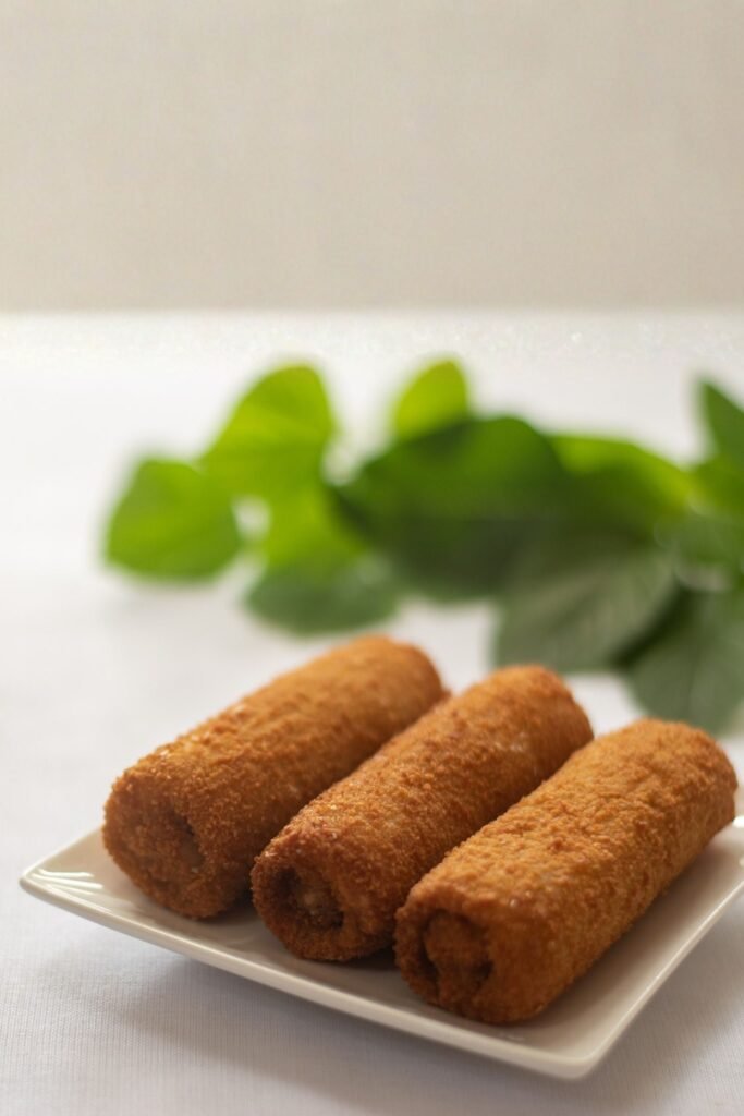 freshly fried fish rolls on a plate in Sri Lanka