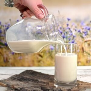 natural fresh milk in transparent glass with milk splash