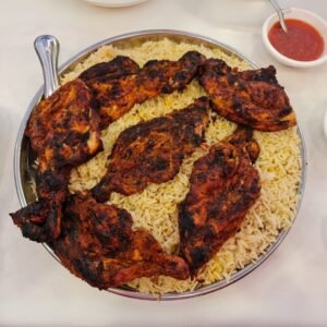 Plate of spicy mutton biriyani served with raita