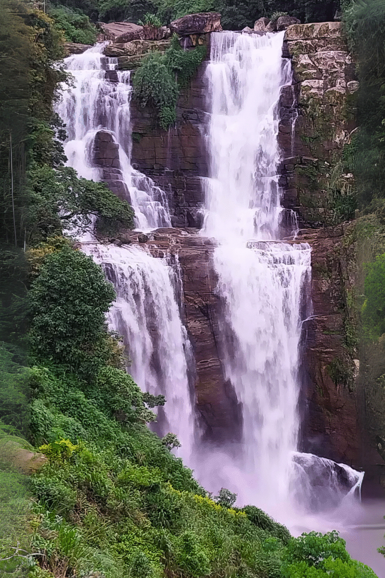 view of Ramboda waterfall with lush tropical forest backdrop