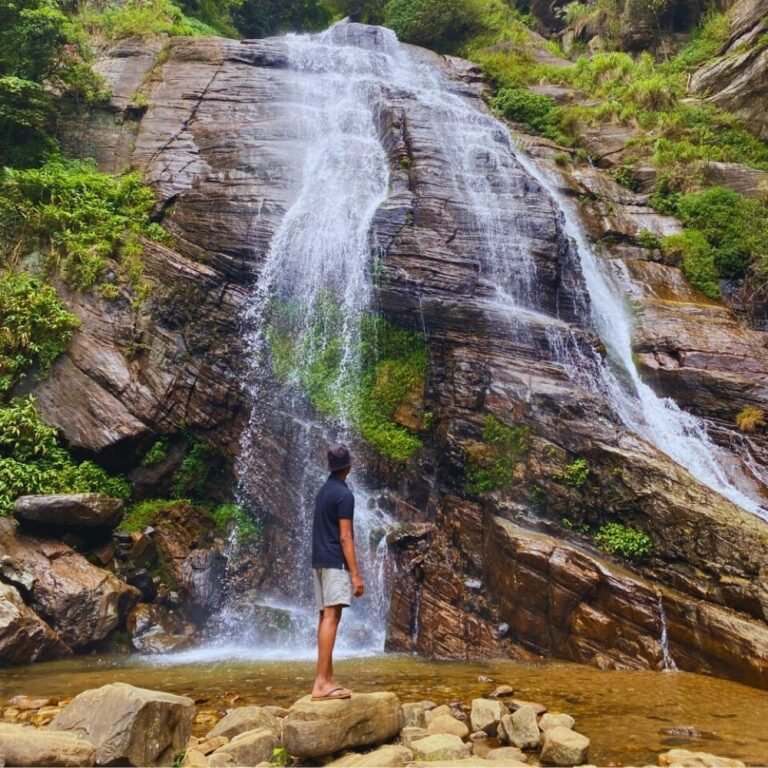 Tourists enjoying the serene beauty of Kolapathana waterfall