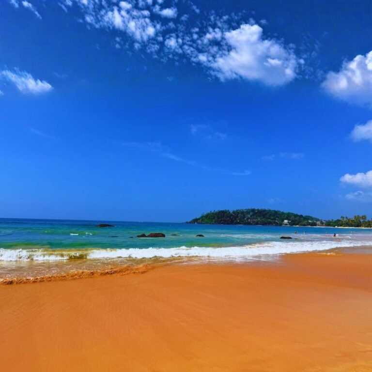 Surfing waves at Mirissa Beach on the southern coast