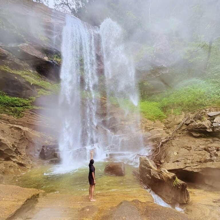 Tourist enjoying the natural beauty at Kabaragala Falls